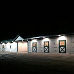 Shed row horse barn at night