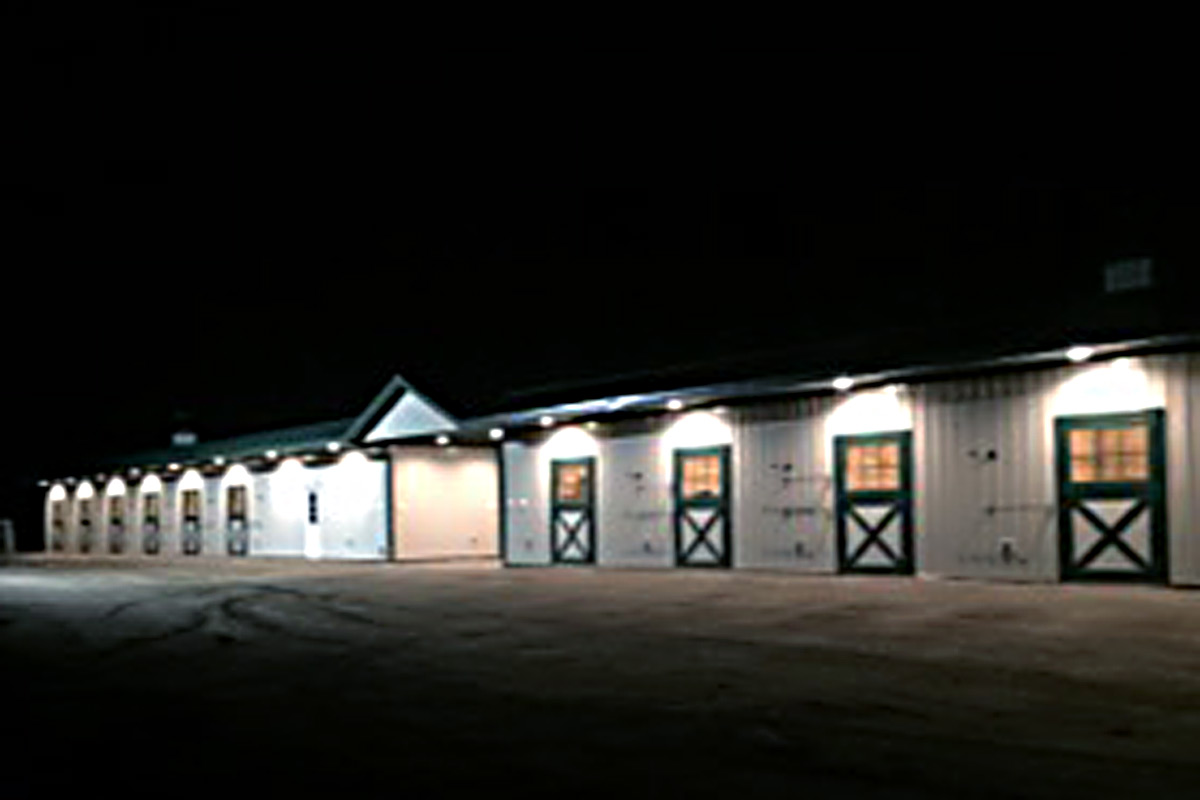 Shed row horse barn at night